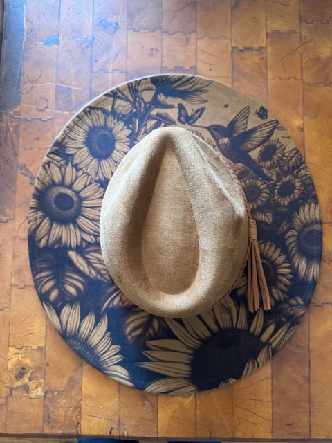 Camel brown colored suede hat laser engraved with sunflowers and a hummingbird